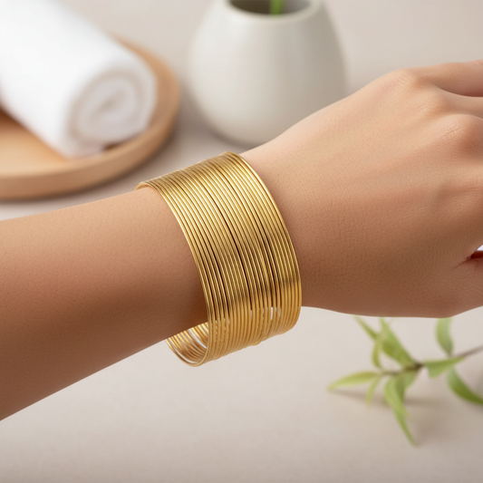 Gold memory wire spring bangles worn on a woman's wrist - Arnia CraftyGirl