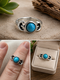 Silver-plated ring with round turquoise stone. Crescent moon detail on the sides size 17
