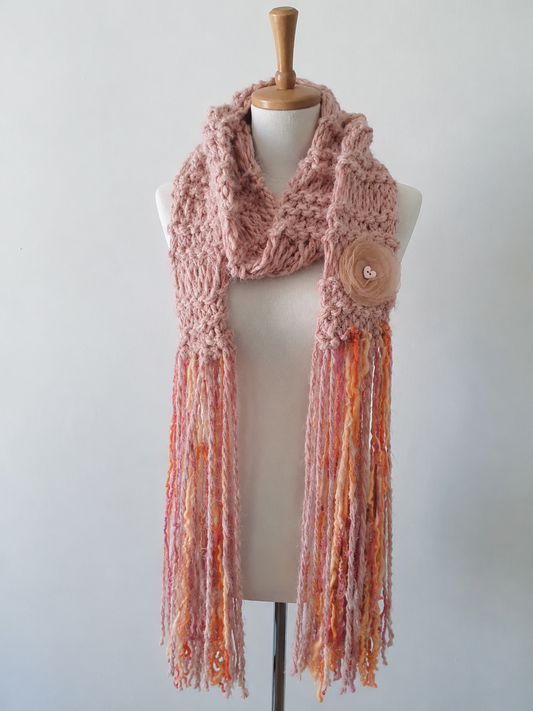 Handcrafted blush pink chunky knit artyarn scarf with peach orange fringe and fabric flower brooch on mannequin - Arnia CraftyGirl