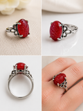 Silver plated ring with scroll detail and red glass stone with gold detail